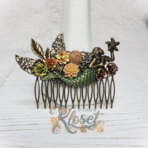 Green mermaid holding a starfish hair comb